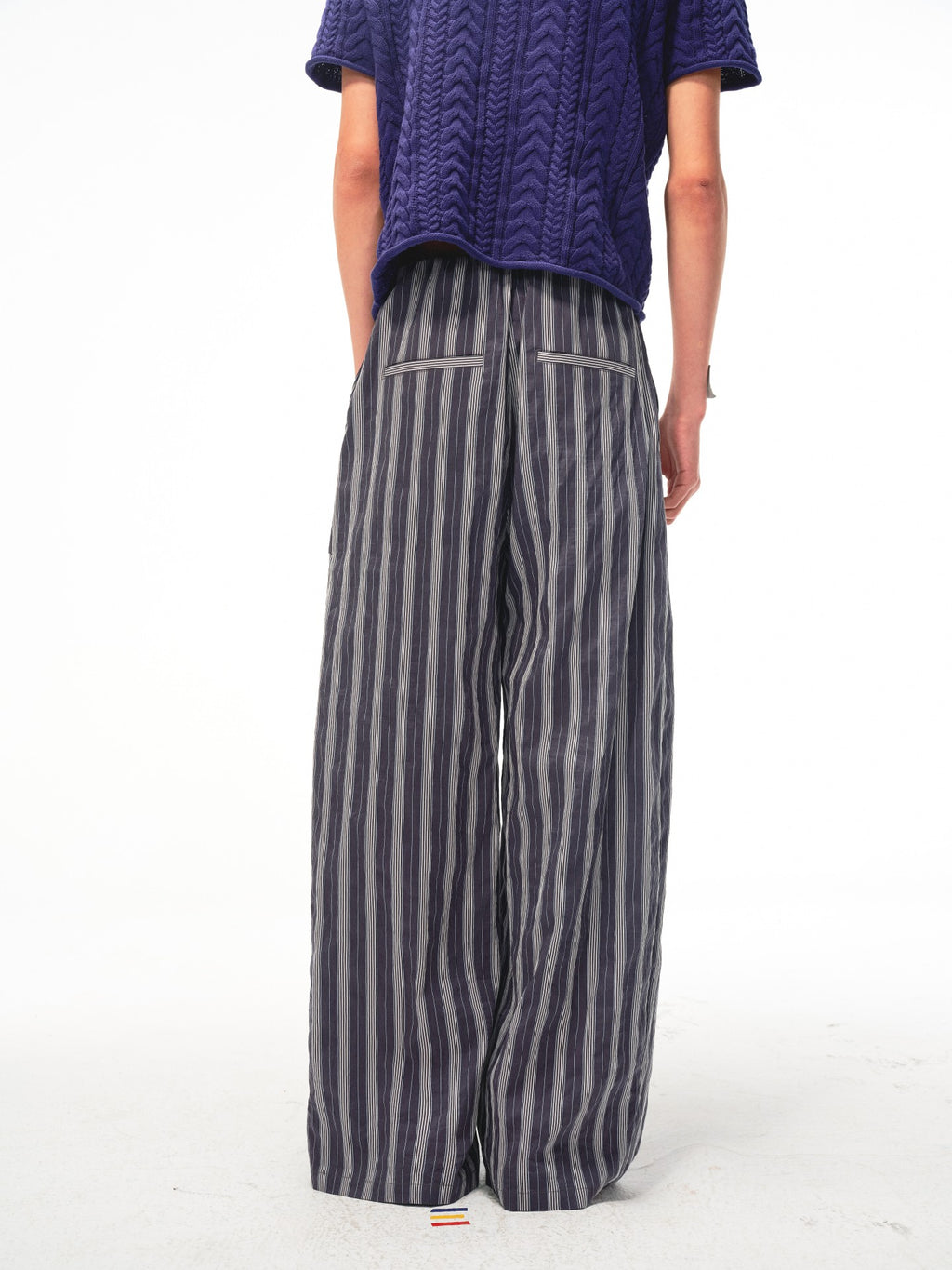 JCAESAR Armored‑style striped trousers with curved side panels